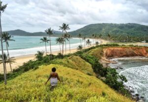 Woman Standing on Hill Near the Sea Graphic Wallpaper